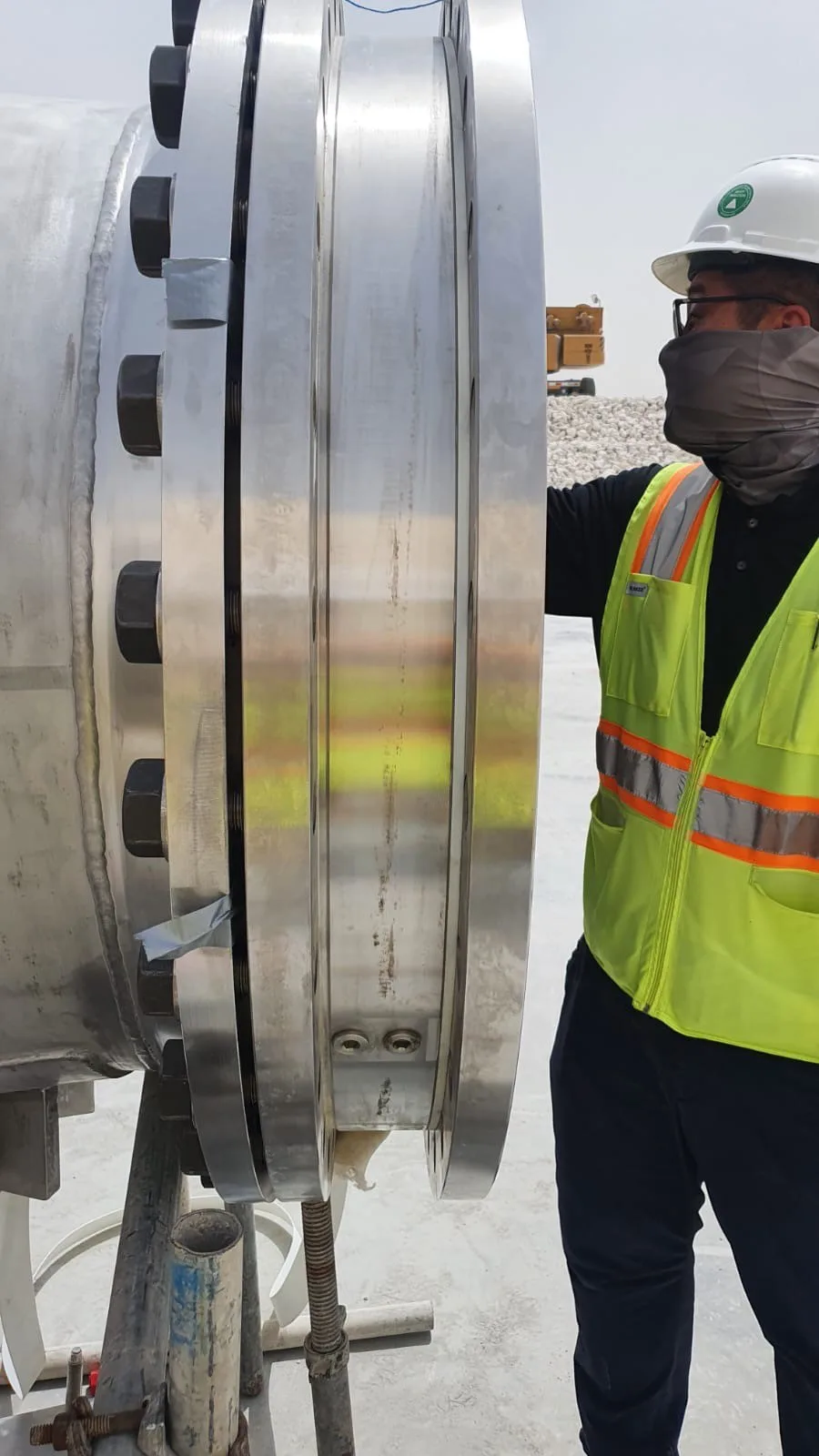 Technician next to a large swivel joint