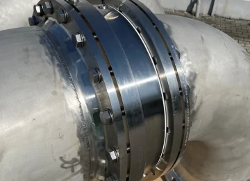Close-up of a swivel joint on a stainless steel pipe bend