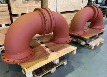 Red-primed swivel joint elbows on pallets